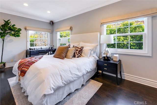 bedroom with crown molding and dark hardwood / wood-style floors