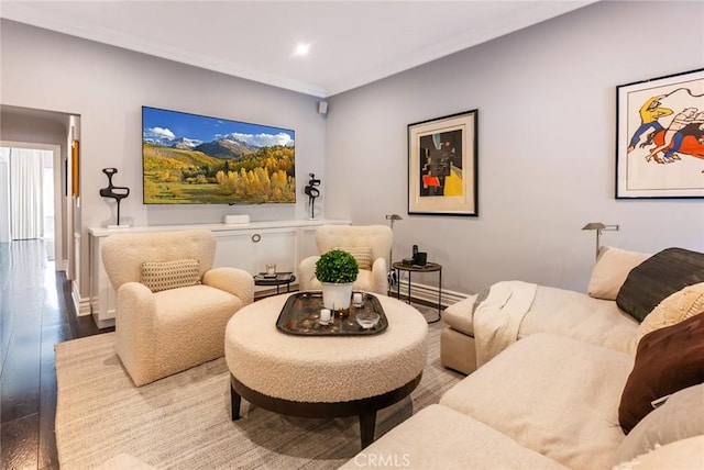 living room with ornamental molding and hardwood / wood-style floors