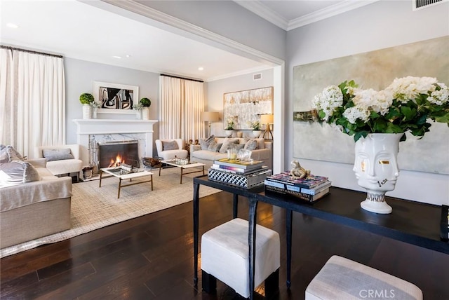 living room featuring crown molding, hardwood / wood-style floors, and a high end fireplace