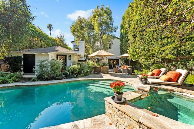 view of swimming pool with an outdoor living space, an outdoor structure, and a patio