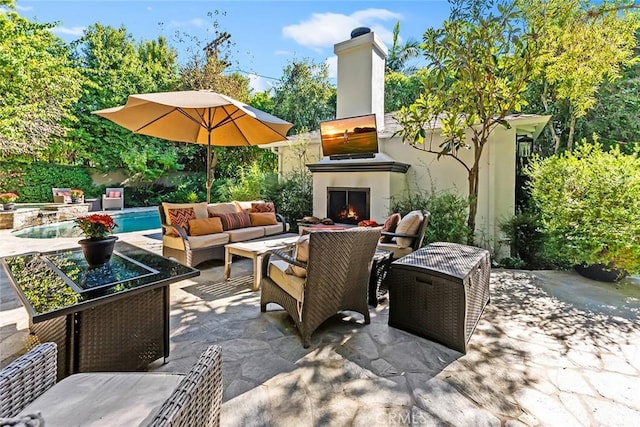 view of patio / terrace featuring an outdoor living space with a fireplace