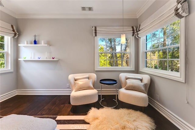 living area with ornamental molding and dark hardwood / wood-style floors