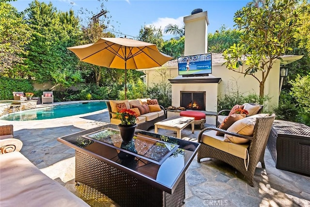 view of patio with an outdoor living space with a fireplace