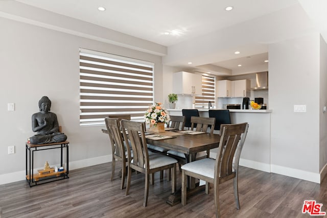 dining space with dark hardwood / wood-style floors and sink