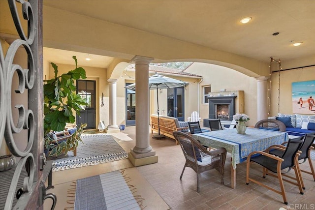 view of patio featuring an outdoor living space with a fireplace