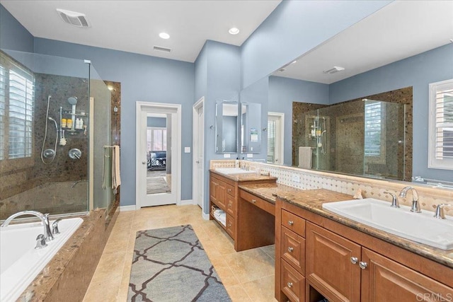 bathroom featuring vanity, visible vents, and a stall shower