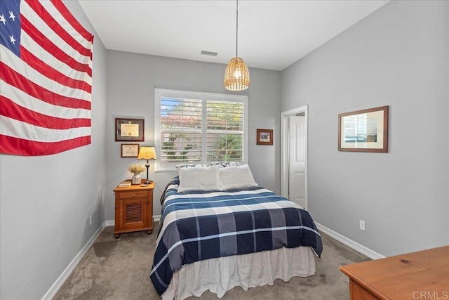 carpeted bedroom featuring visible vents and baseboards