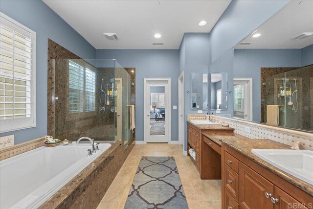 full bathroom with a shower stall, a bath, visible vents, and a sink