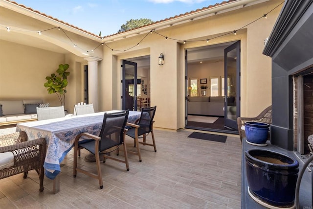 view of patio with a wooden deck and outdoor dining area