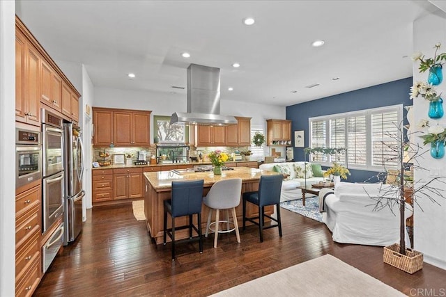 kitchen featuring dark wood-style floors, open floor plan, tasteful backsplash, and island range hood