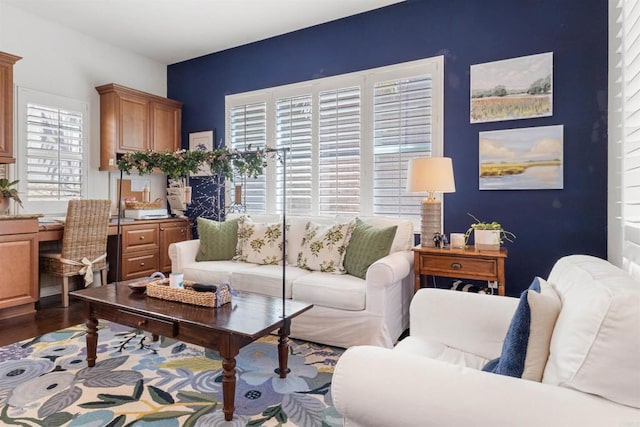 living room with wood finished floors and an accent wall