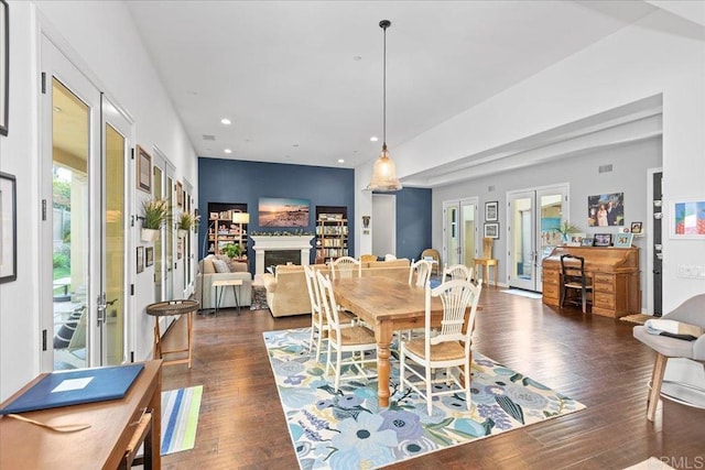 dining room with recessed lighting, french doors, a fireplace, and dark wood-style flooring