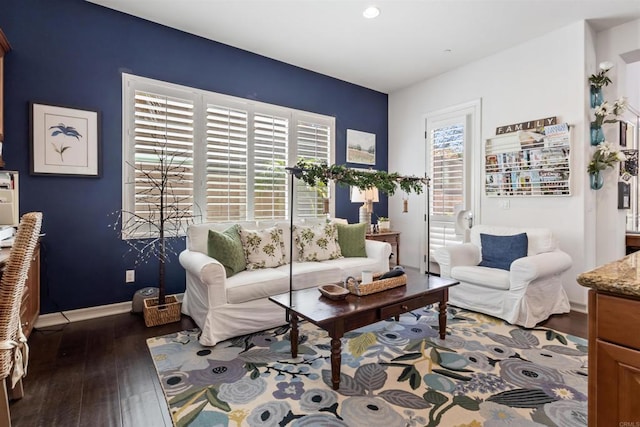 living room featuring plenty of natural light, wood finished floors, and baseboards