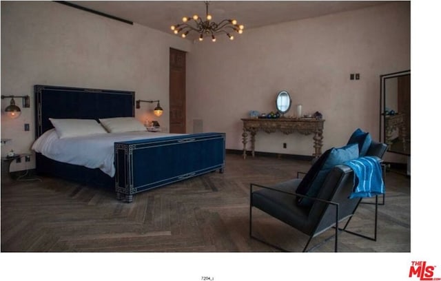 bedroom with dark parquet flooring and a chandelier