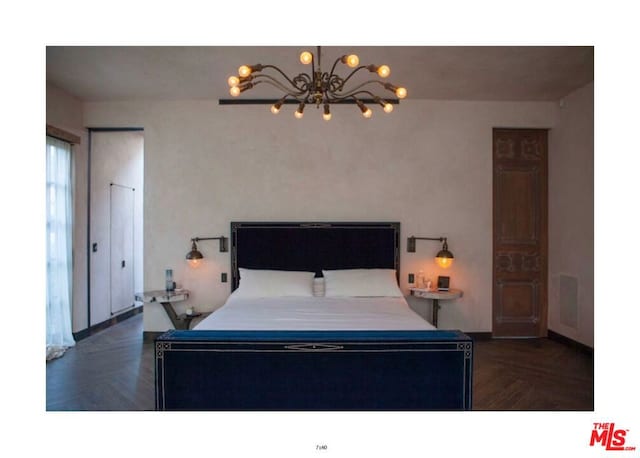 bedroom featuring an inviting chandelier and dark parquet floors