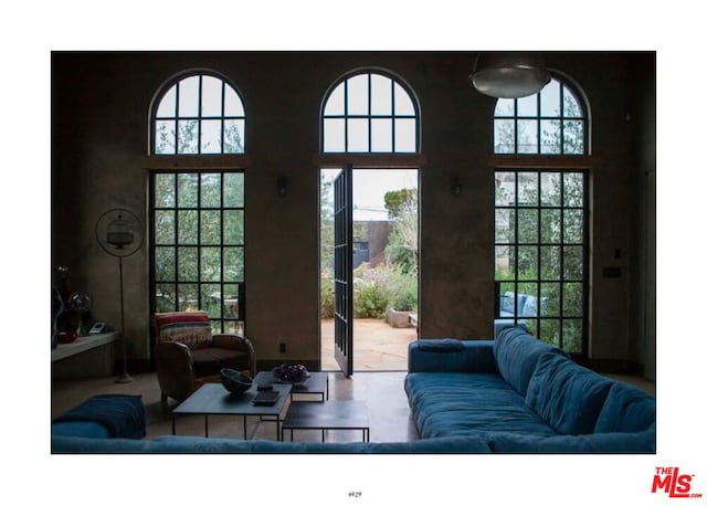 living room with a wealth of natural light and a high ceiling