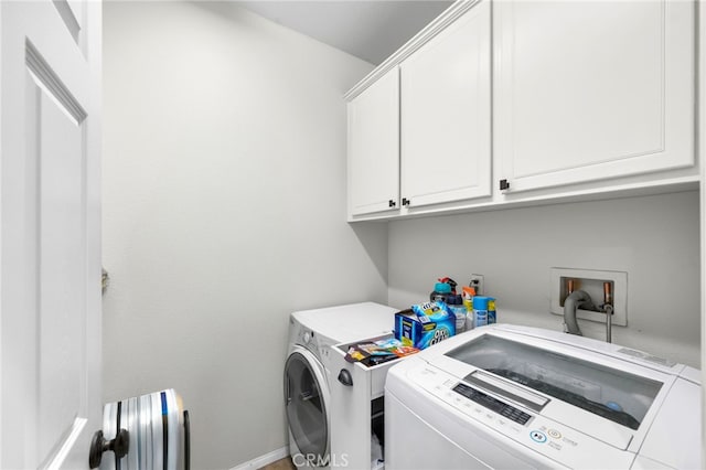 washroom with cabinets, radiator, and washing machine and dryer