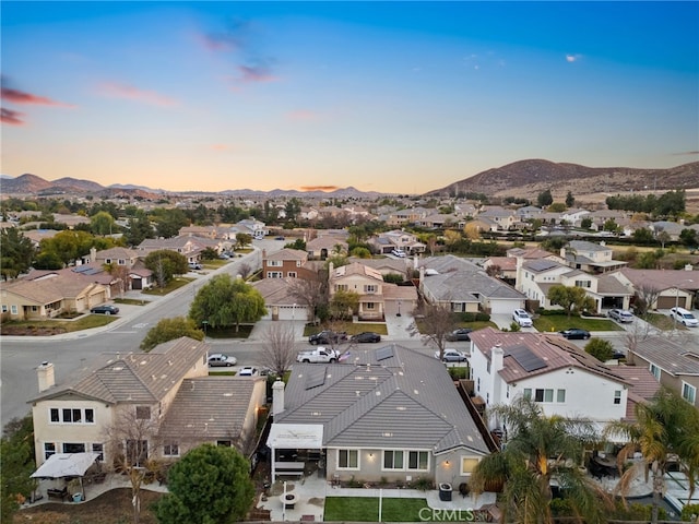 aerial view at dusk featuring a mountain view