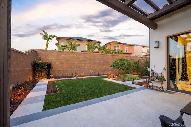 yard at dusk with a patio area