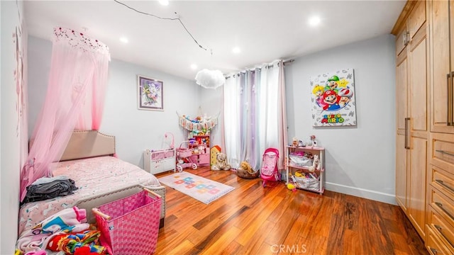 bedroom with dark hardwood / wood-style floors