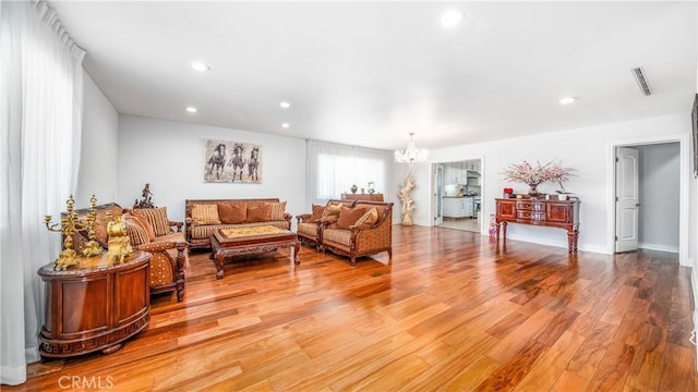 living room featuring hardwood / wood-style floors and a chandelier