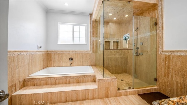 bathroom featuring ornamental molding and shower with separate bathtub