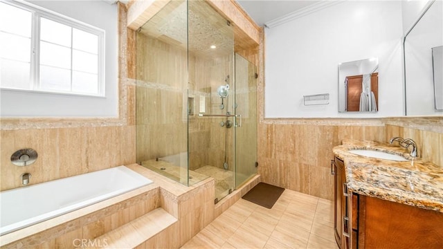 bathroom with tile patterned floors, tile walls, ornamental molding, vanity, and plus walk in shower