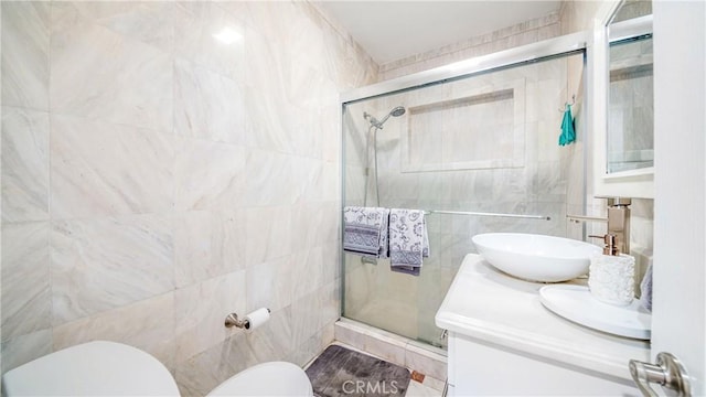 bathroom featuring vanity, tile walls, toilet, and walk in shower