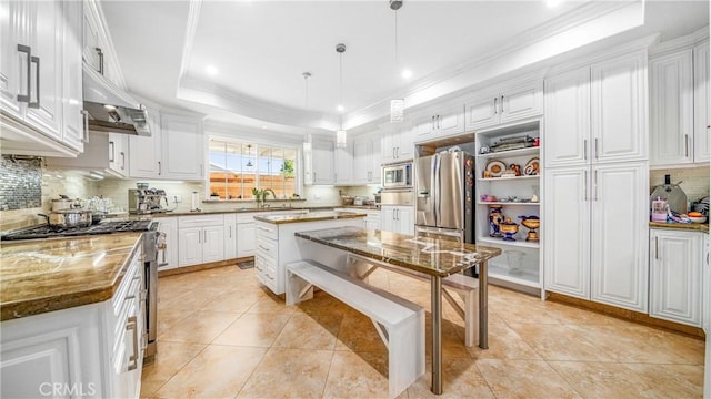 kitchen with dark stone countertops, stainless steel appliances, and white cabinets