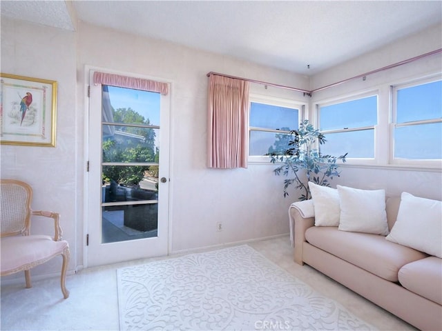 living area with baseboards and carpet floors