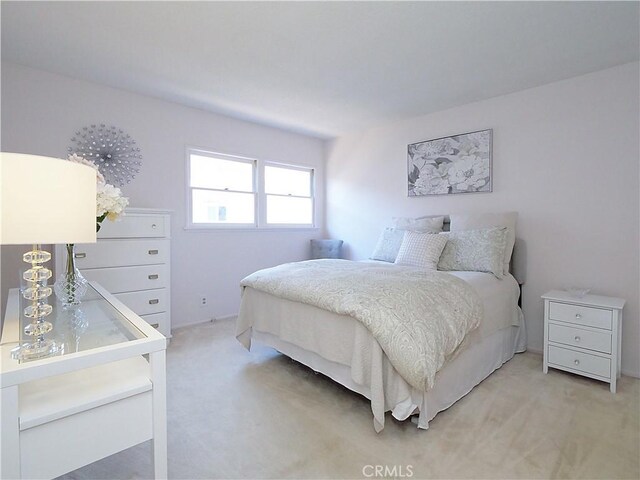 bedroom featuring light carpet