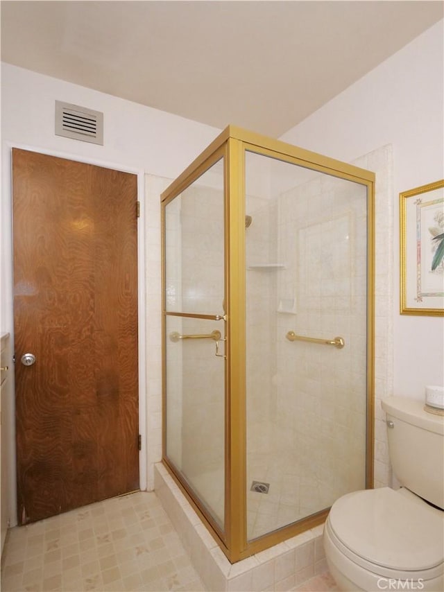 bathroom with toilet and walk in shower