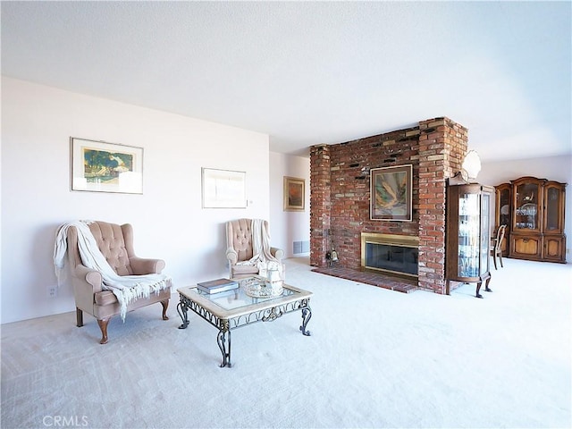 living room featuring carpet and a brick fireplace