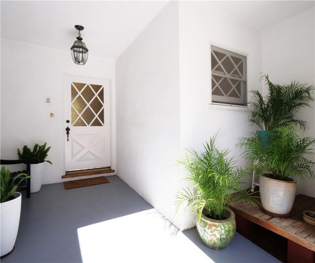 doorway to property featuring stucco siding