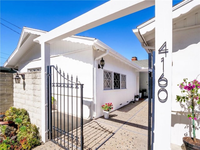 view of side of property with a gate