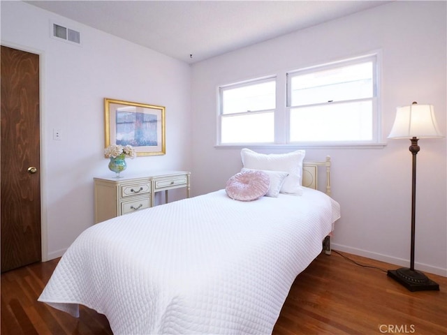 bedroom featuring dark hardwood / wood-style flooring