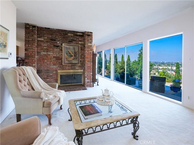 living area featuring carpet and a brick fireplace
