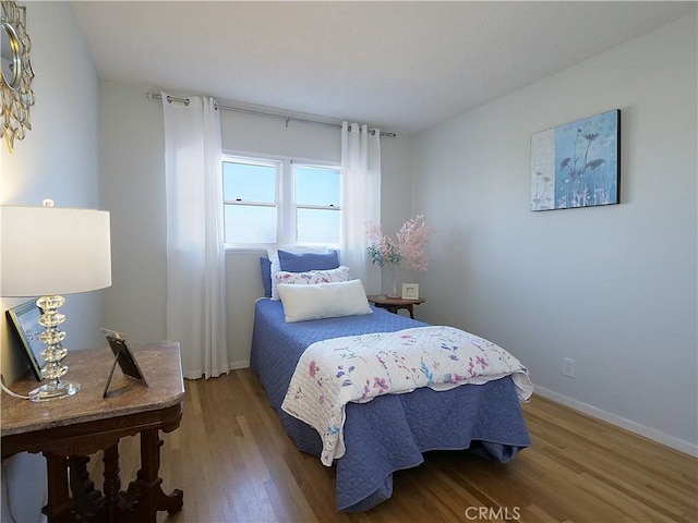 bedroom with hardwood / wood-style floors