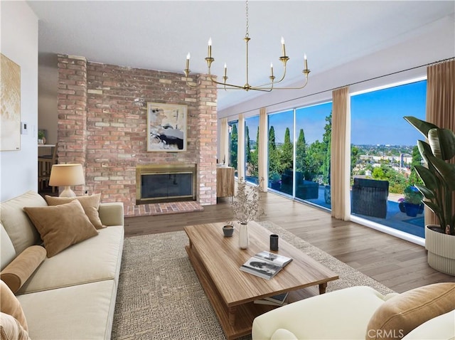 4160 Via Lado, Torrance, CA 90505 - living room featuring wood finished floors, healthy amount of natural light, a brick fireplace, and a chandelier