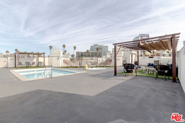 view of swimming pool featuring a pergola and a patio area