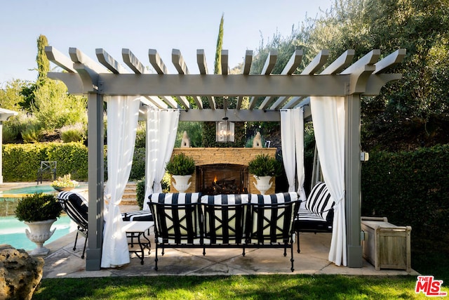 view of patio / terrace with an outdoor living space with a fireplace