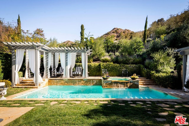 view of swimming pool featuring a yard and a pergola