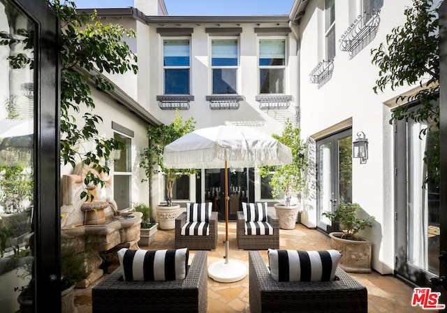 rear view of property with an outdoor hangout area and french doors