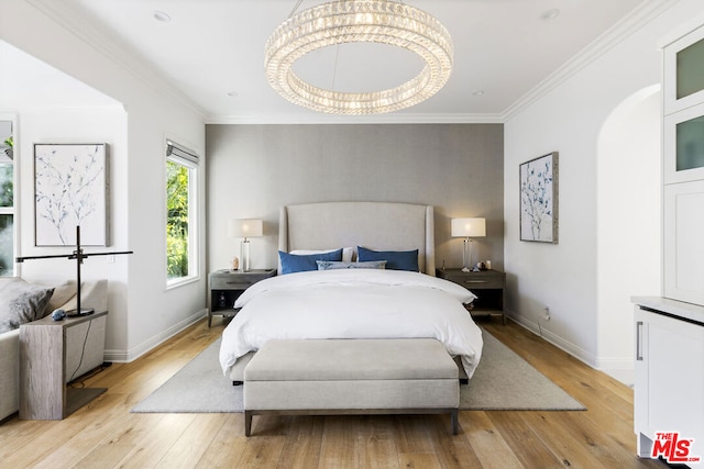 bedroom featuring ornamental molding and light hardwood / wood-style flooring