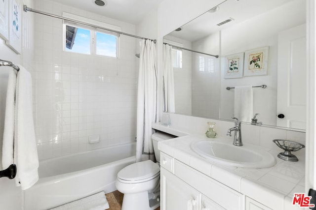 full bathroom featuring vanity, toilet, and shower / bath combo