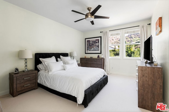 bedroom featuring light colored carpet and ceiling fan