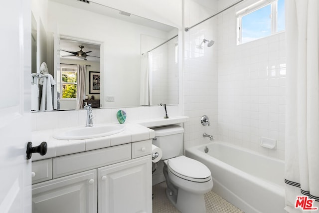 full bathroom with shower / bathtub combination with curtain, vanity, and toilet