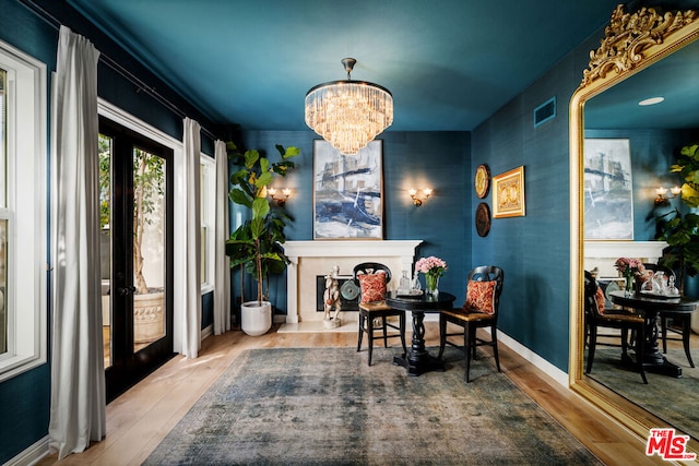 dining area featuring an inviting chandelier and hardwood / wood-style floors