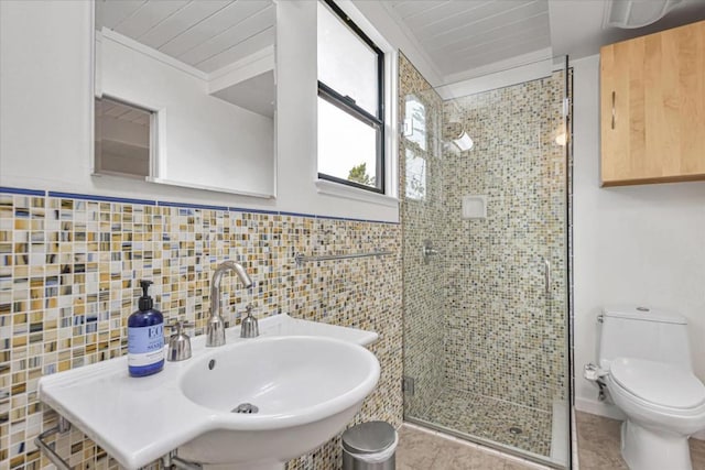 bathroom with crown molding, toilet, an enclosed shower, and tile walls