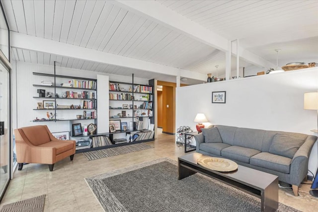 living room with lofted ceiling with beams, built in features, and light tile patterned floors